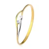 Ring made of yellow and white 9K gold, thin shoulders and waves, clear zircon